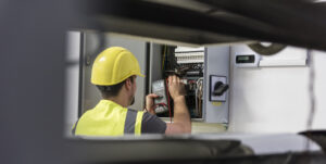 Electrician-testing-for-voltage-in-a-fuse-box-commercial-electrician-norwich-excel-electrical-electrical-testing