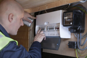 electrician-checking-a-fuse-board-image-electrical-testing-&inspecting-norfolk-commercial-electrician-norwich-electrician-norwich